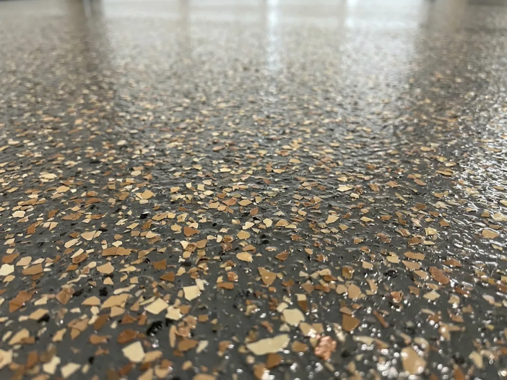 Glossy polyaspartic topcoat over decorative flake, close up